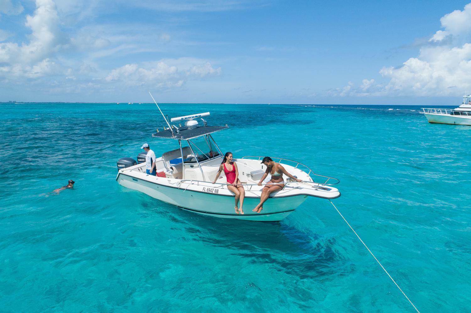 Aerial photo of young women sitting on a boat in Sting Ray City