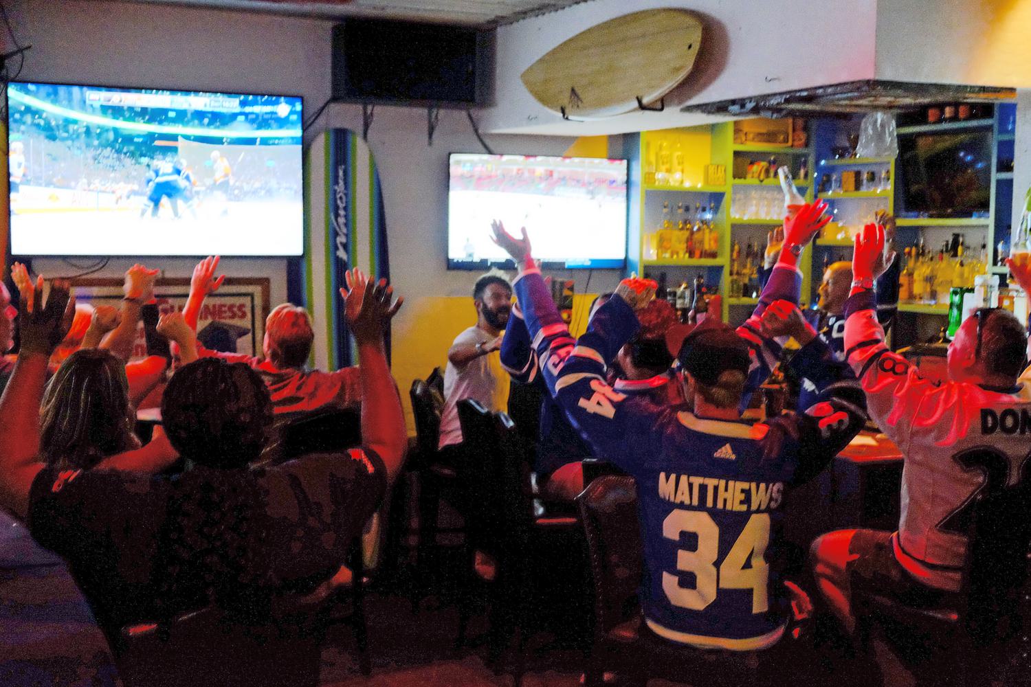 Group of people cheering watching sports
