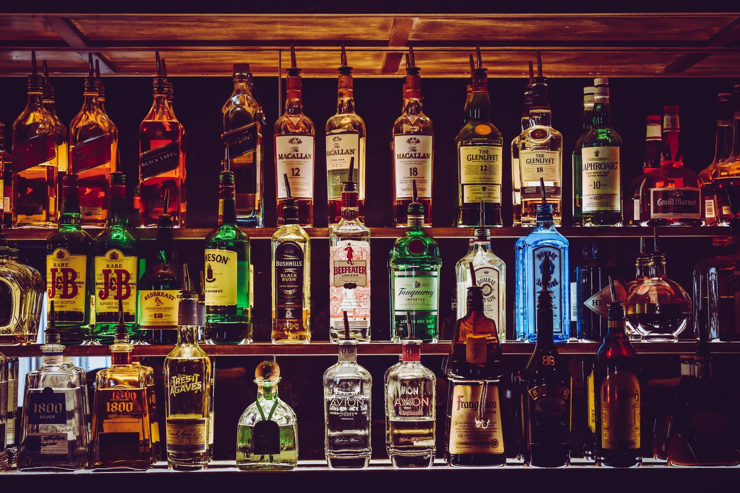 Dark backlit bar full of premium liquor