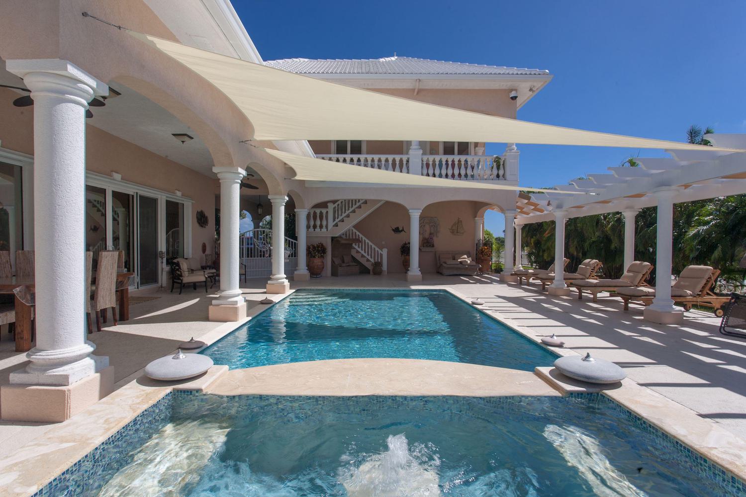 Outdoor patio over looking luxury hottub and pool