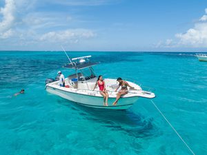 Aerial photo of young women sitting on a boat in Sting Ray City