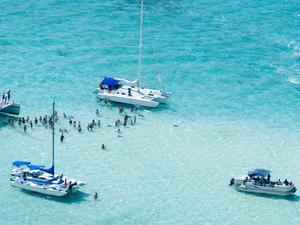 Aerial shot of boats anchored in Stingray City in the Cayman Islands