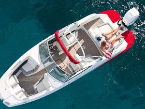 Aerial shot of a couple relaxing on a floating speed boat