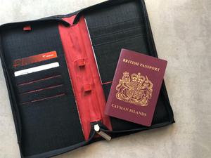 Cayman passport laying open on a passport holder