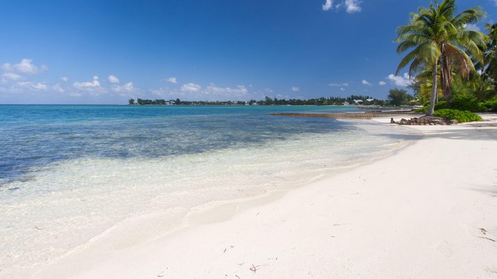 Crystal blue waters with dock in the distance at Cayman Kai