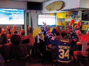 Group of people cheering watching sports