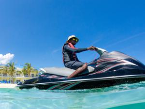 Guy with hat and sunglasses on a jetski in Cayman