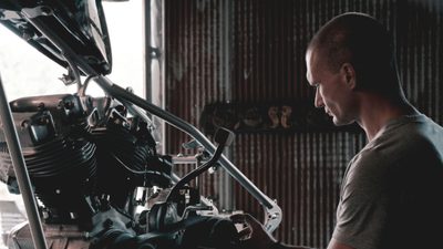 Mechanic working on a car engine in a garage