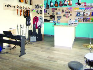 Music shop with several guitars hanging in the walls