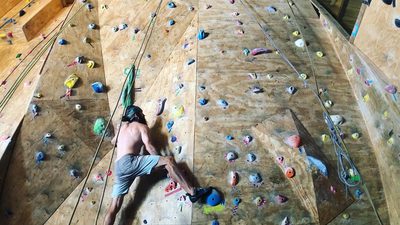 Person indoor rock climbing