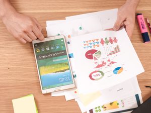 Person reviewing charts with highlighter