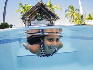 Pool Maintenance Young Girl Swimming Underwater in Pool