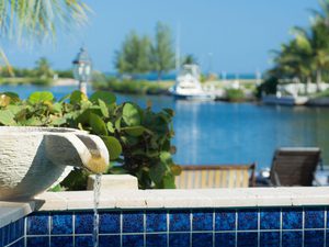 Pool overlooking a tropical canal with fountain