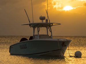 Speed boat anchored offshore during sunset