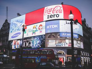 Big corporate brand neon lit signs in picadilly square london england