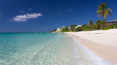 Blue sky crystal clear beach on boggy sand road
