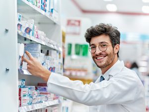 Brunette man working behind the counter at the pharmacy