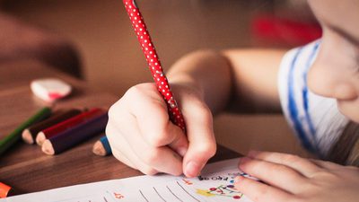 Close up of girl writing
