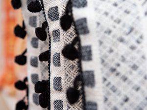 Close up of throw pillows with diffent peach and black patterns