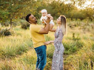 Couple with newborn on an evening stroll