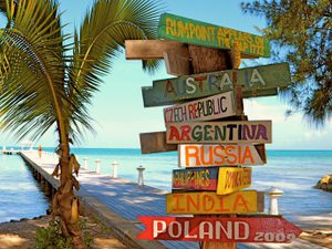 Directional sign overlooking rum point dock and ocean