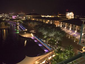 Drone shot of Camana Bay lit up at night
