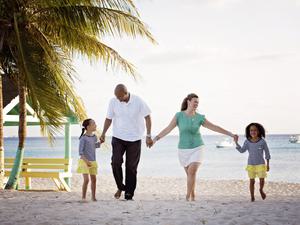 Family walking hand in hand down the beach