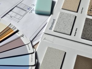 Gray paint swatch book near tile samples