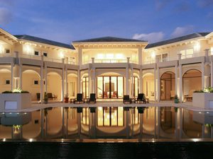 Luxury home at dusk with large infinity pool