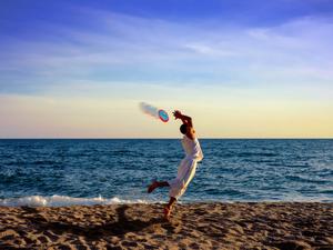 Man jumping for ultimate frisbee beach