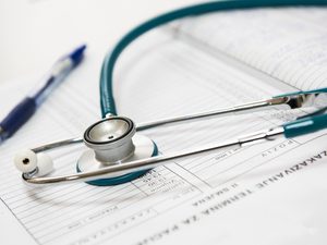 Open stethescope resting on an appointment book blur