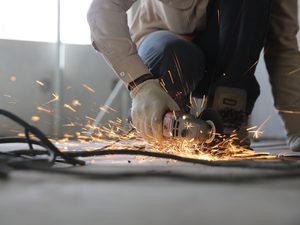 Person holding grinder with sparks