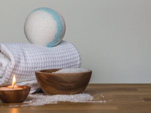 Photo of towel and bath bomb near candle